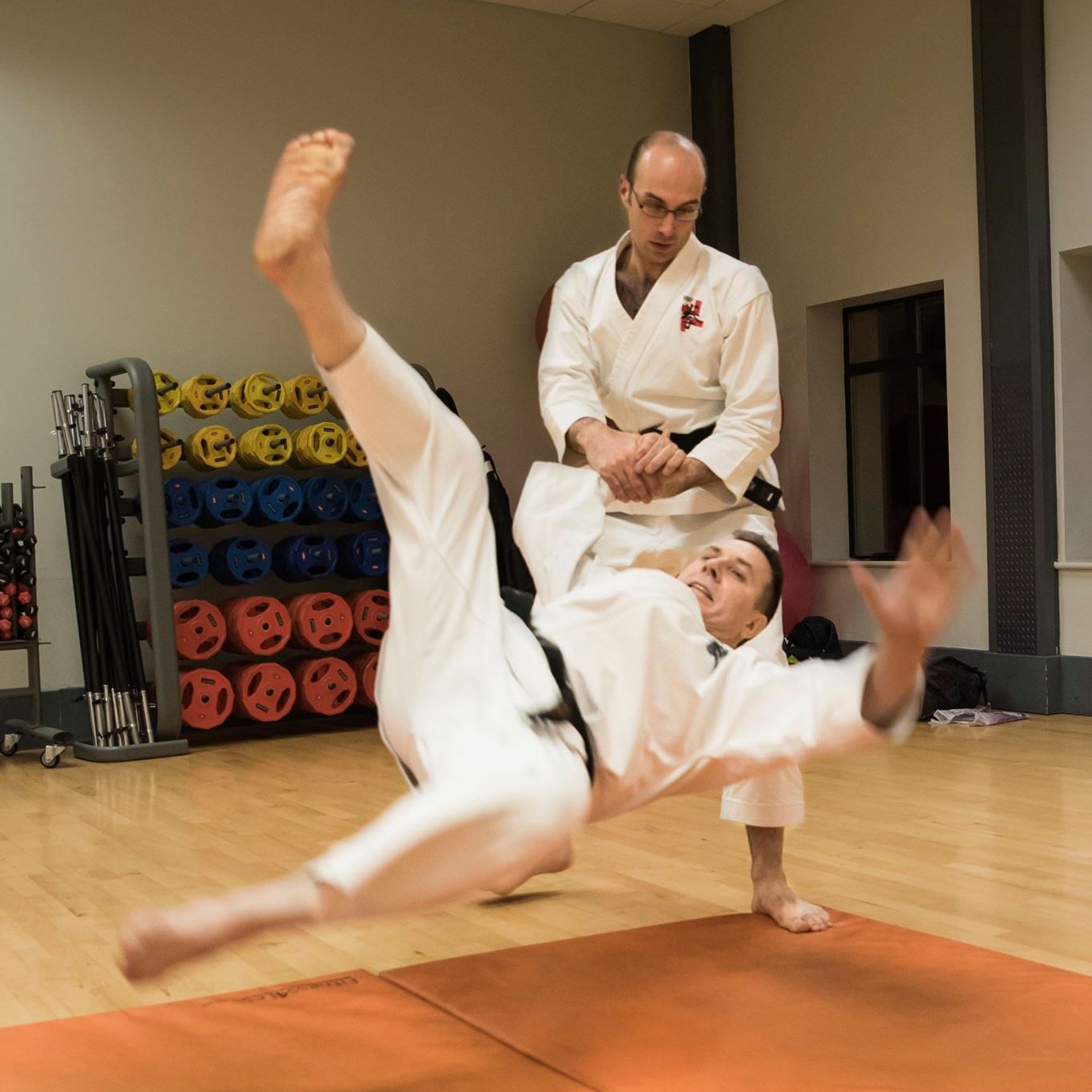 Throwing techniques are often practiced on mats for safety.